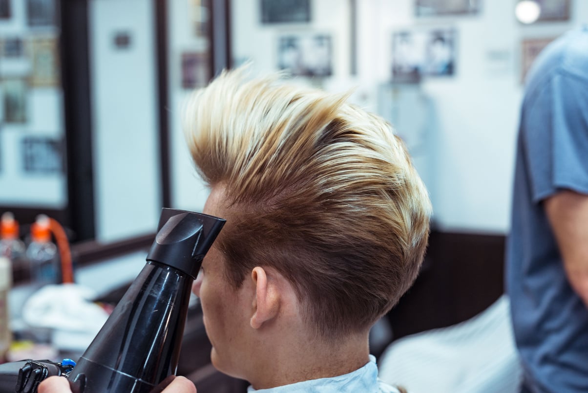 Men's haircut and styling in barbershop. Stylish Haircut Haircut.