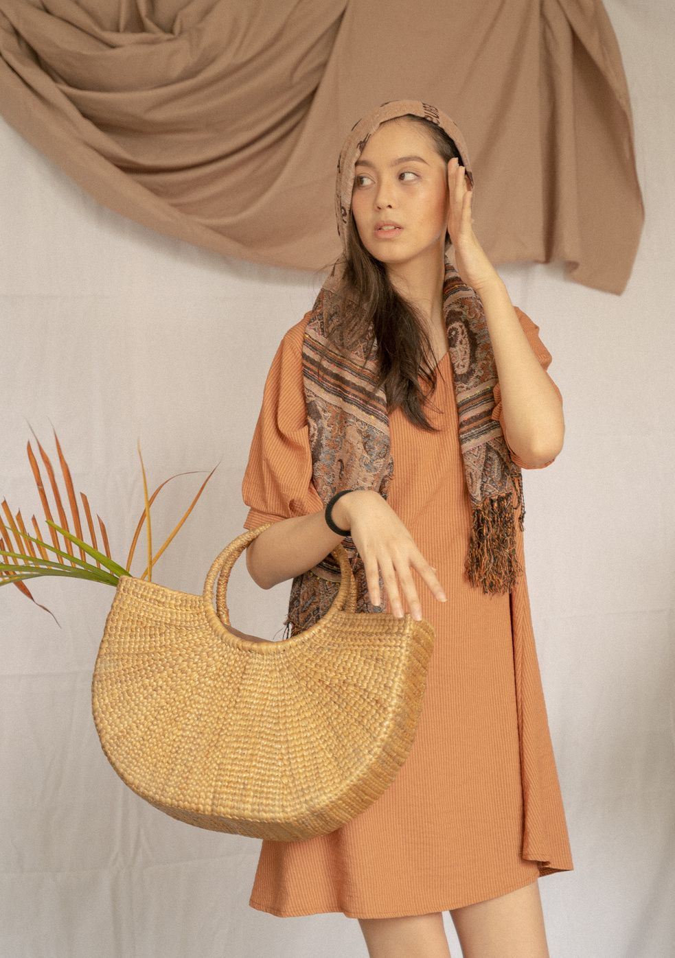 Young Woman in Brown Dress with Headscarf and Native Bag